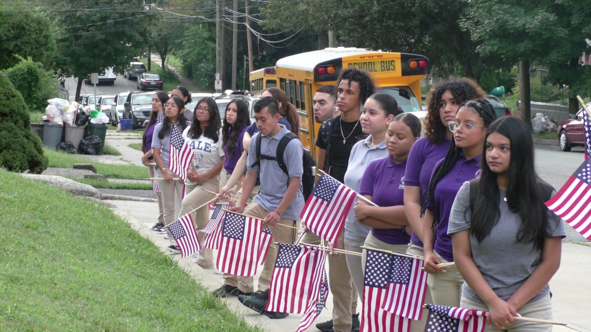 Passaic Prep seniors line up with American flags during the 9/11 Memorial ceremony. 