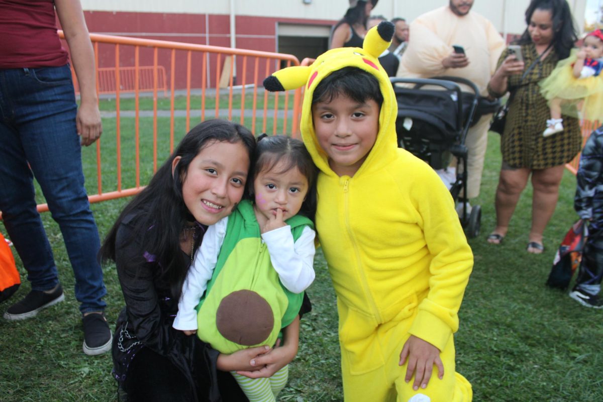 Siblings dressed up as a Witch, Avocado, and Pikachu