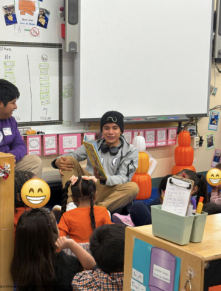 Luis Leon-Reyes, center, and Luis Marrujo read to a Pre-K class at School 15.